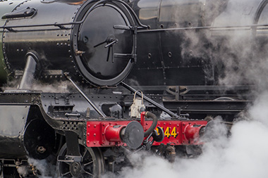 steam locomotive engine with black and red parts showcasing the number 44 representing historical significance and 19th century transport