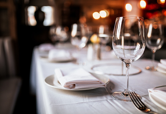 beautifully set dining table with elegant glassware and neatly folded napkins suitable for a special occasion for two diners